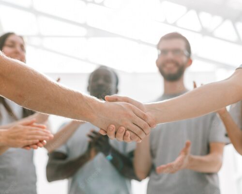close-up-handshake-two-students-background-student-team-photo-with-copy-space_160672-18480